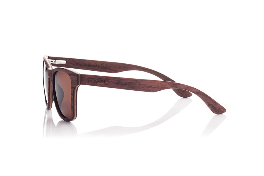 Wood eyewear of Rosewood MARIO. MARIO wooden sunglasses are a classic and timeless model that will perfectly complement any masculine look. Made entirely of laminated rosewood with a thin layer of maple interspersed, the combination of dark and light tones creates an elegant and subtle contrast. Fitting comfortably against the head, the temples are made from the same laminated wood for added durability. Classic styling and high-quality craftsmanship make these sunglasses a sophisticated and fashionable choice. Lenses available in solid shades of gray and brown provide full protection from the sun's rays. Front Measurement: 145x48mm Caliber: 52 for Wholesale & Retail | Root Sunglasses® 